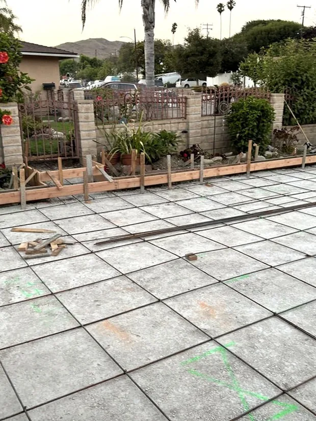 A large back yard slab scored into a regular grid of squares